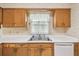 Kitchen view with a window, stainless steel sink, dishwasher and classic cabinets at 620 Marshall St, Altamonte Springs, FL 32701