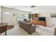 Comfortable living room with a large window, entertainment center, and neutral carpet and paint at 620 Marshall St, Altamonte Springs, FL 32701
