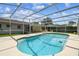 Beautiful in-ground pool with a screened enclosure and outdoor seating area at 620 Marshall St, Altamonte Springs, FL 32701