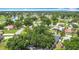 High-angle view of a residential area showcasing tree-lined streets, well-spaced houses, and a backdrop of natural landscapes at 620 Wood Dr, Kissimmee, FL 34759