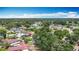 Wide aerial perspective of a diverse residential community featuring various home styles and verdant landscaping with mature trees at 620 Wood Dr, Kissimmee, FL 34759