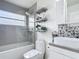 Bathroom featuring a shower/tub combo, a modern sink, and decorative shelves at 620 Wood Dr, Kissimmee, FL 34759
