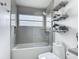 Bathroom features a shower/tub combo and modern shelving at 620 Wood Dr, Kissimmee, FL 34759