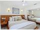 Bright bedroom featuring a ceiling fan, wall sconces, and a large mirrored closet at 620 Wood Dr, Kissimmee, FL 34759