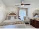 Comfortable bedroom features a decorative ceiling fan and a tufted accent chair at 620 Wood Dr, Kissimmee, FL 34759