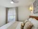 Bright bedroom featuring a ceiling fan and a large window with sheer curtains at 620 Wood Dr, Kissimmee, FL 34759