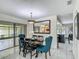 Inviting dining area with a modern chandelier and sliding glass doors to the outdoors at 620 Wood Dr, Kissimmee, FL 34759