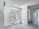 Bright foyer with tile flooring, decorative front door with sidelight, and access to other rooms at 620 Wood Dr, Kissimmee, FL 34759