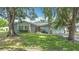 Charming home with mature trees and green lawn in a peaceful residential neighborhood at 620 Wood Dr, Kissimmee, FL 34759