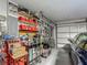 Garage with tools, shelving, and a blue car; organized space for projects and storage at 620 Wood Dr, Kissimmee, FL 34759