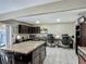 Large kitchen featuring an island with seating, dark cabinets, and a built-in workstation at 620 Wood Dr, Kissimmee, FL 34759