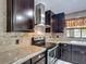 This kitchen features dark cabinetry, stainless steel appliances and granite countertops at 620 Wood Dr, Kissimmee, FL 34759