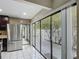 Bright kitchen with stainless steel fridge, tile floors and backyard access through sliding glass doors at 620 Wood Dr, Kissimmee, FL 34759
