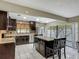 Well-equipped kitchen with dark cabinetry, stainless steel refrigerator, and island seating at 620 Wood Dr, Kissimmee, FL 34759