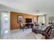 Open-concept living room featuring tile floors, a wall-mounted TV, and comfortable seating at 620 Wood Dr, Kissimmee, FL 34759