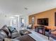 Cozy living room with tile flooring, comfortable seating, and access to other rooms at 620 Wood Dr, Kissimmee, FL 34759
