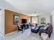 Well-lit living room featuring tile floors, a modern TV, and stylish decor at 620 Wood Dr, Kissimmee, FL 34759