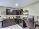 Home office area featuring dark cabinetry, granite countertops, one work station and tile flooring at 620 Wood Dr, Kissimmee, FL 34759