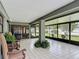 Enclosed patio features white tiled floor, a decorative column, and multiple sliding glass doors for seamless indoor-outdoor living at 620 Wood Dr, Kissimmee, FL 34759
