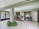 Enclosed tiled patio includes decorative plants and lots of windows at 620 Wood Dr, Kissimmee, FL 34759