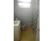 Simple bathroom featuring a vanity, toilet, and shower with a patterned curtain at 6251 Bolling Dr, Orlando, FL 32808