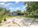 Exterior showcasing the side and back of the house, accented by a backyard and a large concrete pad at 660 6Th St, Daytona Beach, FL 32117
