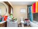 Untidy bathroom with tub, shower, toilet, cabinet and washing machine at 660 6Th St, Daytona Beach, FL 32117