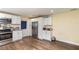 Bright kitchen with white cabinetry, stainless steel refrigerator, and wood-look flooring at 660 6Th St, Daytona Beach, FL 32117