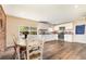 Open-concept kitchen with white cabinets, laminate countertops, and wood-look flooring at 660 6Th St, Daytona Beach, FL 32117