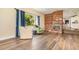 Cozy living room showcasing a charming brick fireplace, hardwood floors and natural light at 660 6Th St, Daytona Beach, FL 32117