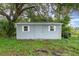 Exterior of a one-story shed with two windows and a grey door at 660 6Th St, Daytona Beach, FL 32117