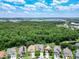 An aerial shot of the neighborhood reveals a mix of homes, green foliage and commercial development nearby at 6843 Cherry Grove Cir, Orlando, FL 32809