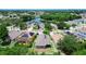 Expansive aerial view capturing the neighborhood's serene lake, lush greenery, and well-spaced homes at 6843 Cherry Grove Cir, Orlando, FL 32809