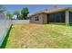 Open backyard showcasing a screened in porch, defined by a white fence, offering privacy and outdoor enjoyment at 6843 Cherry Grove Cir, Orlando, FL 32809