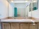 Bright bathroom featuring a double vanity with framed mirror and a shower/tub combo with modern fixtures at 6843 Cherry Grove Cir, Orlando, FL 32809
