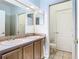 Bathroom featuring double sinks, vanity and tiled floors, enhancing the home's appeal at 6843 Cherry Grove Cir, Orlando, FL 32809