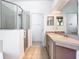 Bright bathroom featuring a glass-enclosed shower, double sinks, and ample counter space for convenience at 6843 Cherry Grove Cir, Orlando, FL 32809
