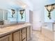 Elegant bathroom with double sinks, large mirror, and soaking tub, creating a relaxing and functional space at 6843 Cherry Grove Cir, Orlando, FL 32809