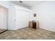 A bedroom featuring sliding closet doors, ceramic tiled flooring, and a small desk and chair at 6843 Cherry Grove Cir, Orlando, FL 32809