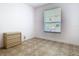 A quaint bedroom featuring ceramic tile floors, natural light, and electrical outlets at 6843 Cherry Grove Cir, Orlando, FL 32809