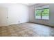 Well-lit bedroom with tile flooring, large window and a door at 6843 Cherry Grove Cir, Orlando, FL 32809