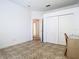Bedroom featuring neutral walls, tile floors, a desk and sliding door closet at 6843 Cherry Grove Cir, Orlando, FL 32809