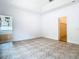 Spacious bedroom with tile floors, view of a bathtub, and walk in closet at 6843 Cherry Grove Cir, Orlando, FL 32809