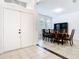 Bright dining room features decorative dark wood table and chairs, and two arched windows at 6843 Cherry Grove Cir, Orlando, FL 32809