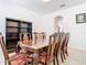 Formal dining room featuring a large wooden table with ornate chairs and tile floors at 6843 Cherry Grove Cir, Orlando, FL 32809