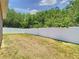 A spacious backyard defined by a pristine white fence and mature trees. Ample space for a garden at 6843 Cherry Grove Cir, Orlando, FL 32809