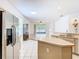 Bright kitchen with stainless steel appliances and an island overlooking the living area at 6843 Cherry Grove Cir, Orlando, FL 32809