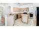 Bright kitchen featuring stainless steel appliances, tile floors and light wooden cabinets at 6843 Cherry Grove Cir, Orlando, FL 32809