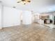 Open living room and kitchen area with tile flooring and ample natural light at 6843 Cherry Grove Cir, Orlando, FL 32809