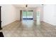 Spacious living room with tile flooring, ceiling fan and sliding door access to the patio at 6843 Cherry Grove Cir, Orlando, FL 32809